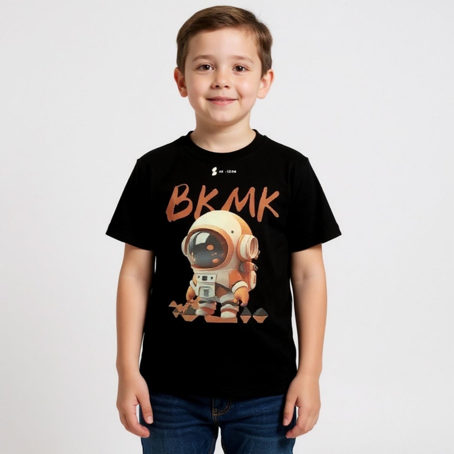 Child wearing a black t-shirt with a robot graphic and 'BKMK' text on a white background