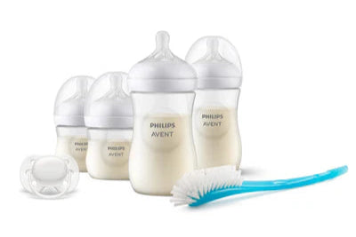 Philips Avent baby bottles, pacifier, and cleaning brush on a white background