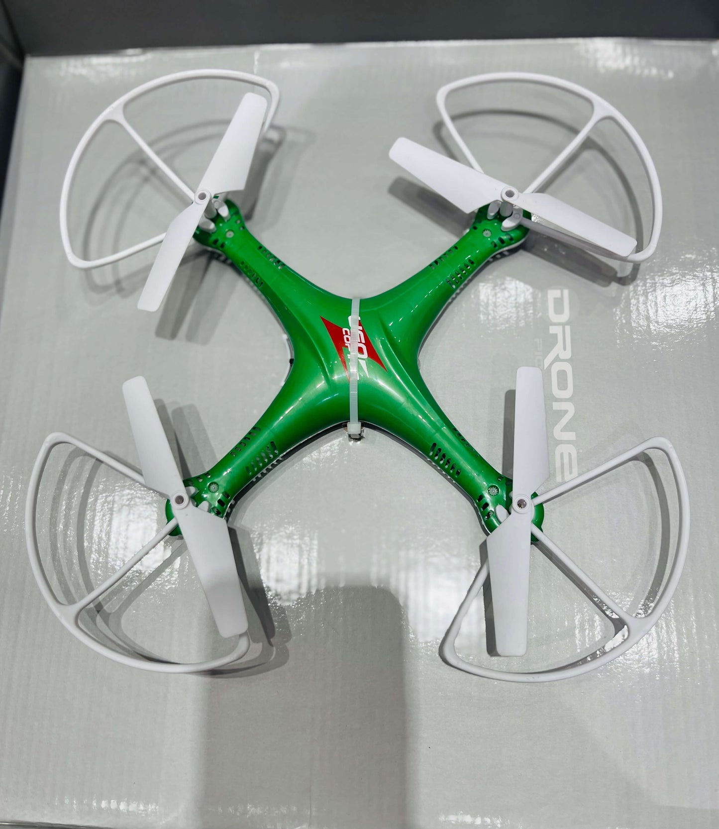 Green drone with white propellers