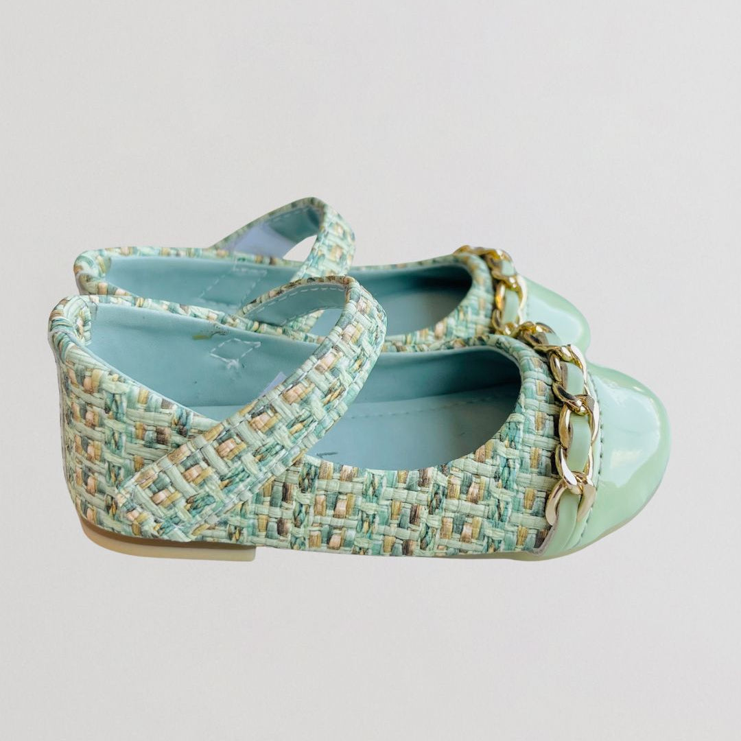Light blue textured shoe with a strap on a light gray background