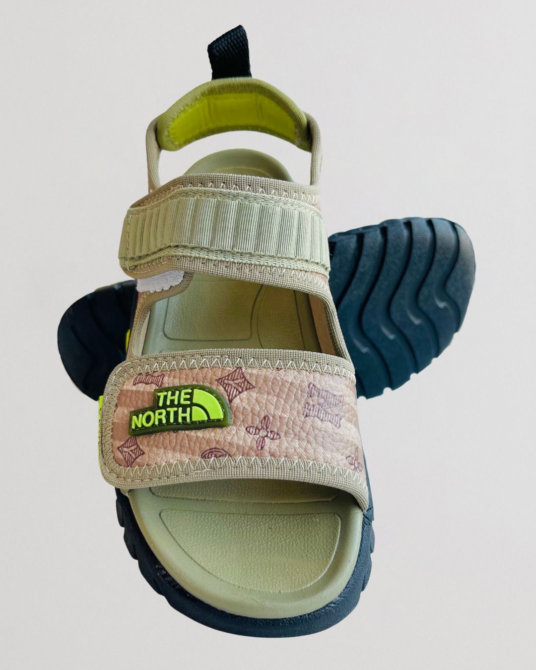 Children's sandal with The North Face logo on a light gray background