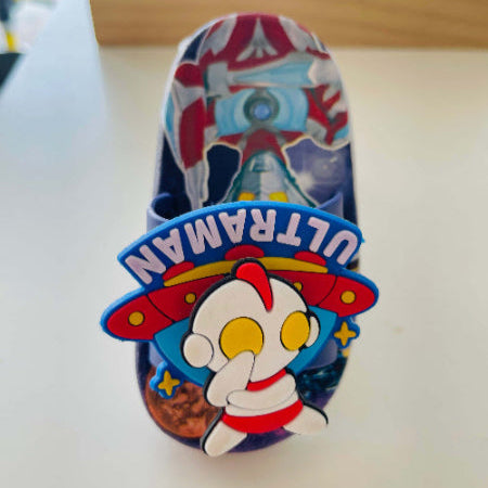 Colorful sandal with Ultraman character design on a white surface