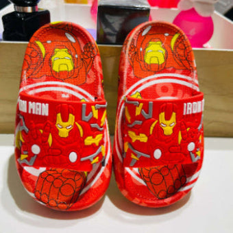 Red children's sandals with superhero designs on a white surface.