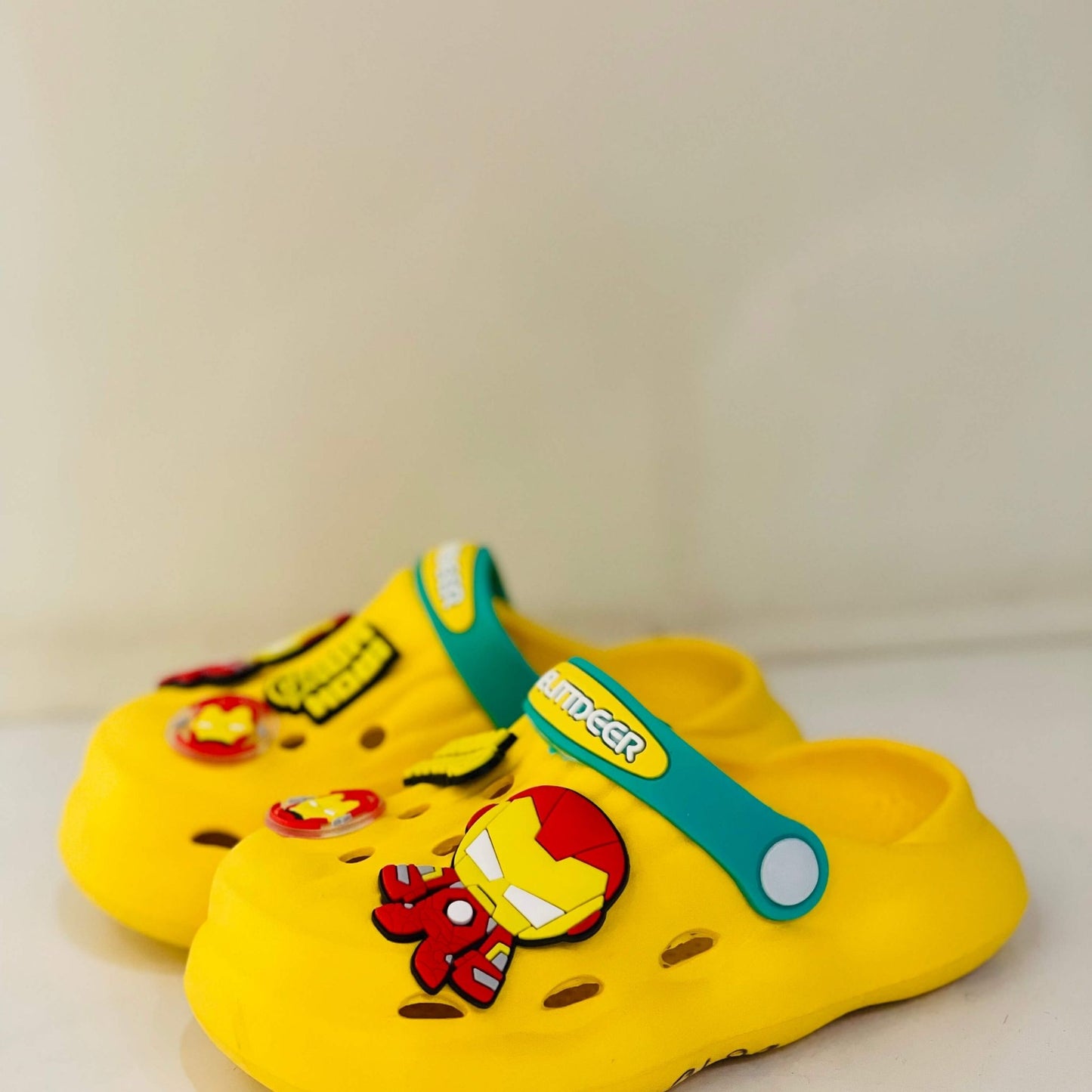 Yellow children's clogs with Iron Man design on a white background