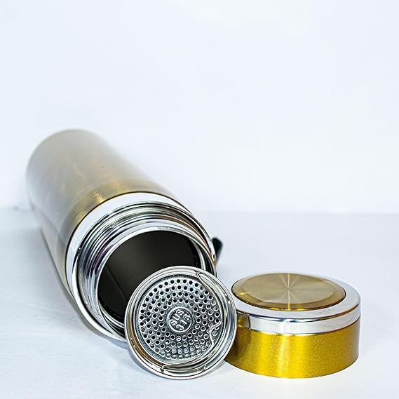 Gold and silver metal container with lid on a white background