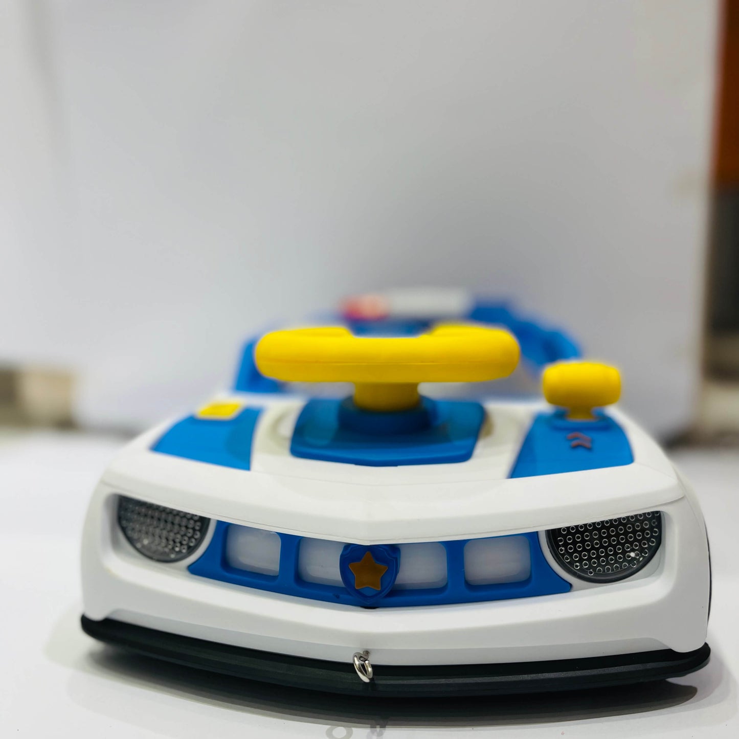 Toy car with a blue and white design on a light background