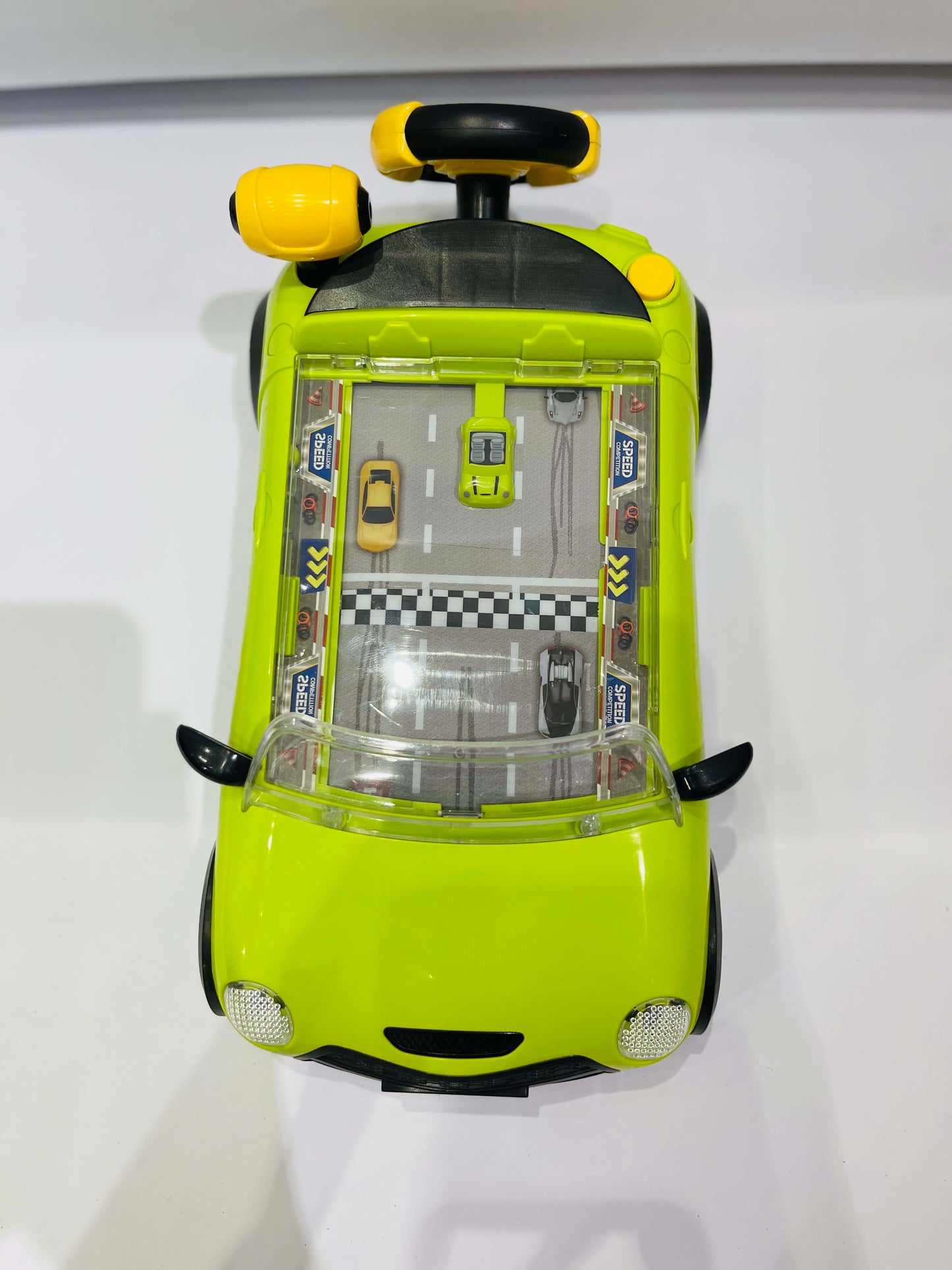 Toy car with a transparent top showing a miniature cityscape on a white background
