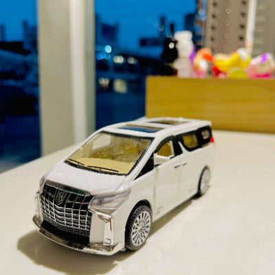 Model toy car on a reflective surface with a blurred background