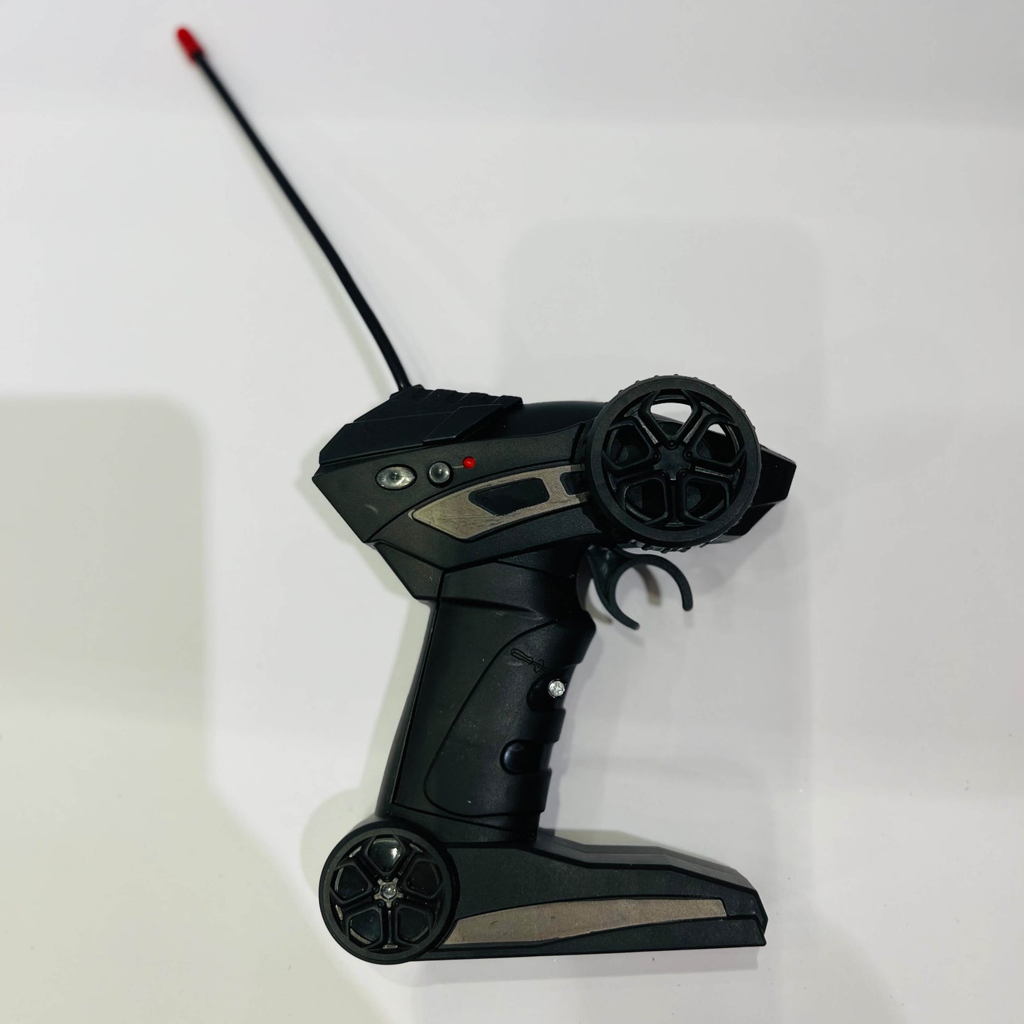 Black remote control with antenna on a white background