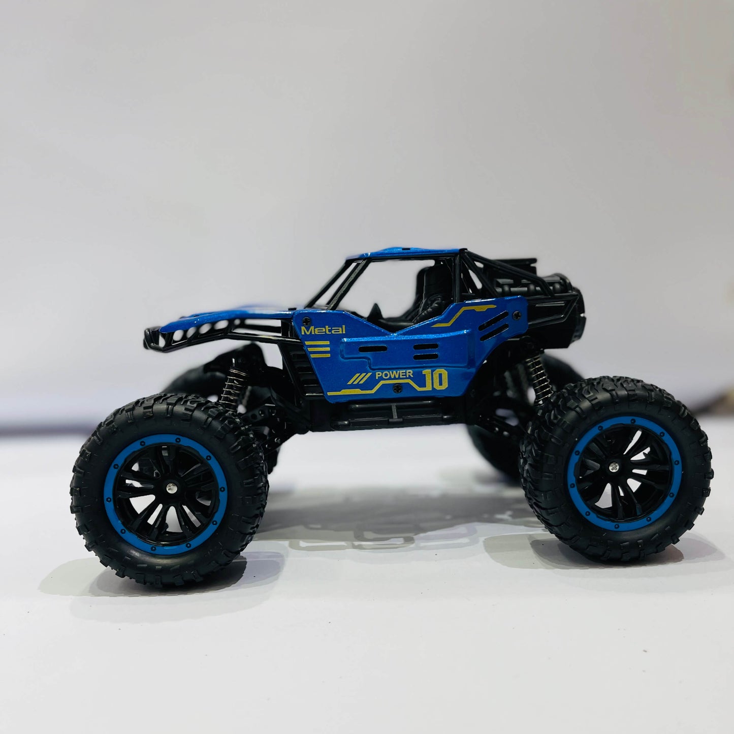 Blue toy off-road vehicle on a white background