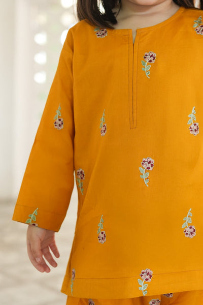 Yellow kurta with floral embroidery on a blurred background