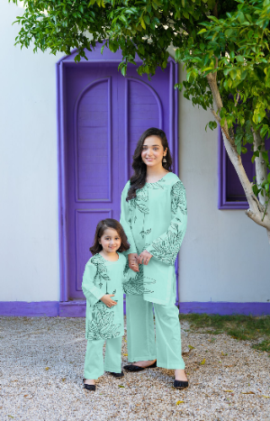 Woman and child in matching outfits standing in front of a purple door and white wall.