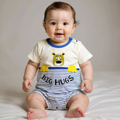 Baby wearing a onesie with a bear design and 'BIG HUGS' text on a plain background