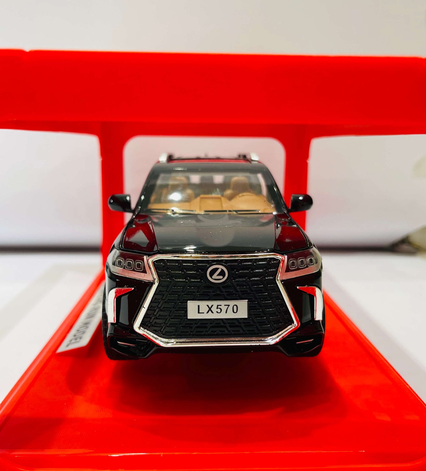  A black diecast model of a Lexus LX570 SUV, viewed from the front Two-quarter angle.