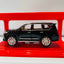 Black SUV model on a red stand with a white background