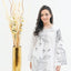 Women wearing a white traditional outfit with floral patterns on a white background