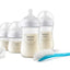 Philips Avent baby bottles, pacifier, and cleaning brush on a white background