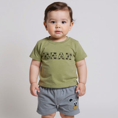 Child wearing a green t-shirt with 'BEAR' printed on it and gray shorts with a bear design.