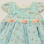 Light blue dress with floral details and embroidery.