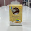 Yellow box of Baby Love Parfums on a white surface with blurred background