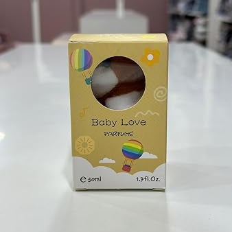 Yellow box of Baby Love Parfums on a white surface with blurred background