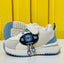 Children's white and blue sneakers with a cartoon character on a yellow background