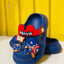 Blue children's clogs with superhero design and visible brand name on a yellow background