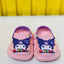 Pink children's shoes with cartoon character and 'Kuromi' branding on a white background.
