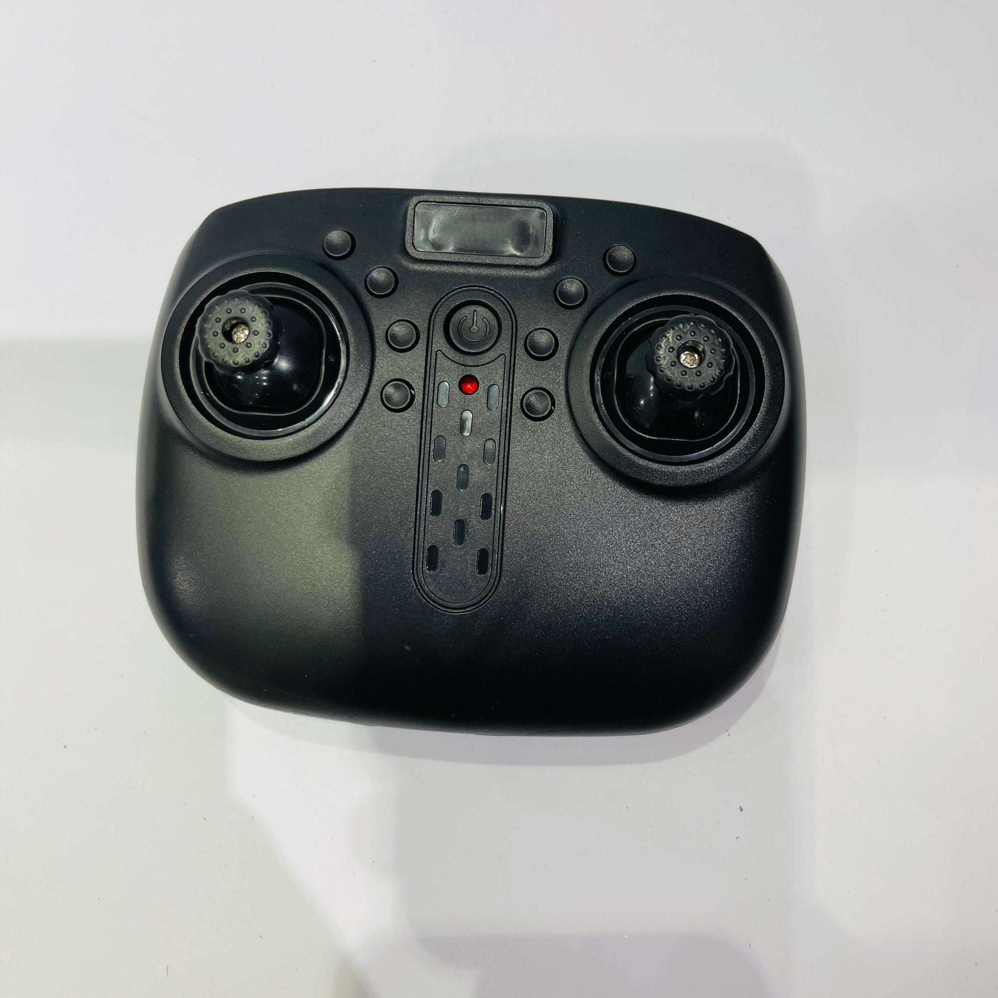 Black remote control device on a white background