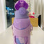 Purple water bottle with cartoon design on a white surface