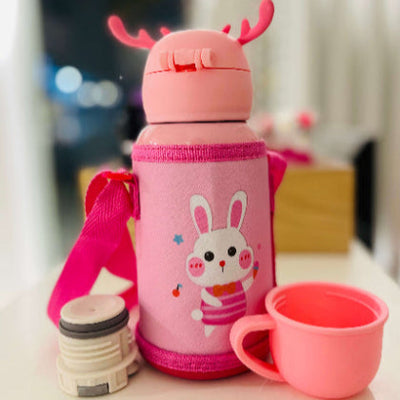 Pink thermos bottle with rabbit design and matching cup on a blurred background