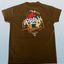 Brown t-shirt with colorful graphic design on a light blue background