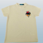 Beige t-shirt with a colorful logo on a light gray background