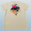 Beige t-shirt with colorful graphic design on a light blue background