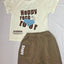 Children's outfit with a beige t-shirt and brown shorts.
