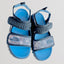 Blue sandals with gray straps on a light gray background