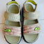 Pair of children's sandals with The North Face logo on a white background