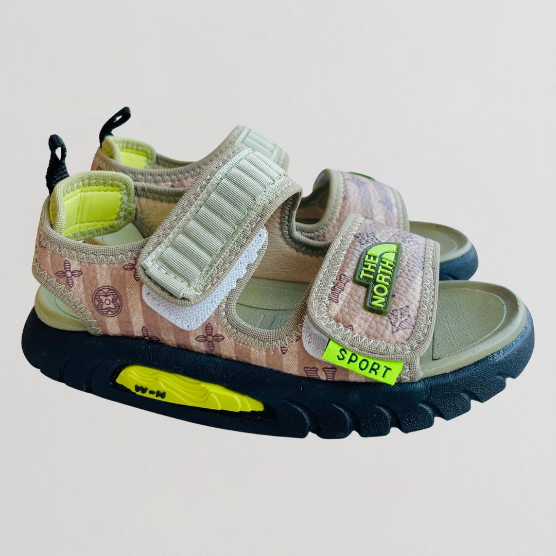 Children's sandals with floral pattern and colorful sole on a light gray background