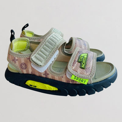 Children's sandals with floral pattern and colorful sole on a light gray background