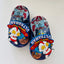 Colorful sandals with Ultraman design on a white background