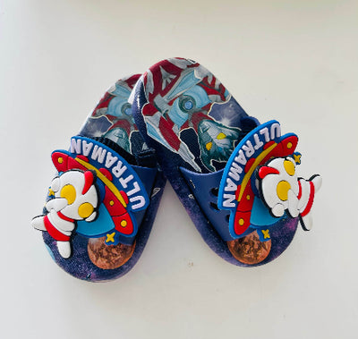 Pair of blue sandals with Ultraman design on a white background