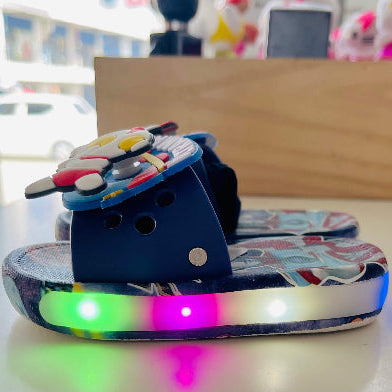 Colorful LED slide shoe on a table with a blurred background