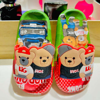 Children's shoes with cartoon bear design on a white background
