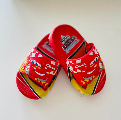 Red children's sandals with cartoon character design on a white background