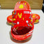 Red superhero-themed sandal with 'Iron Man' design on a white surface