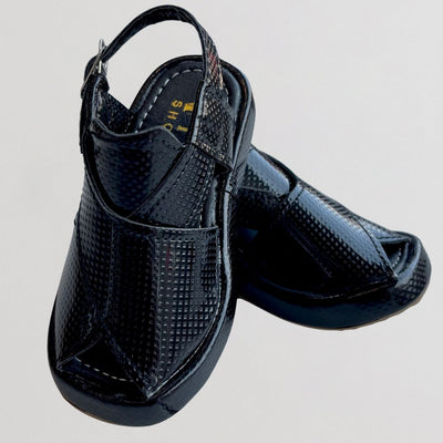 Pair of black textured shoes on a light gray background