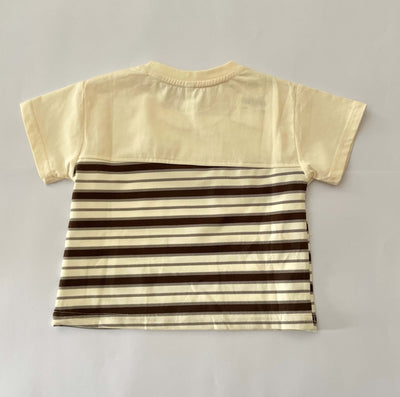 Beige t-shirt with brown and beige striped pattern on a gray background