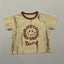 Beige t-shirt with red distressed design.