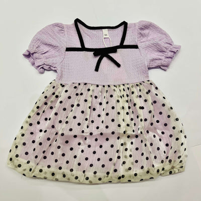 Lavender dress with black polka dots on a white background