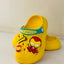 Yellow clog shoe with Iron Man character design on a light background
